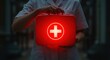 © Boom Boy - Nurse holding illuminated red first aid kit; serious, urgent medical assistance concept.