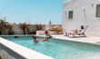 © PintoArt - Family enjoying summer holidays playing in swimming pool of holiday villa