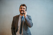 © La Famiglia - Smiling businessman talking on mobile phone in office