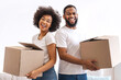 © Prostock-studio - New House. Happy African American Couple Holding Moving Boxes Preparing For Relocation Posing Smiling To Camera Standing In New Apartment. Real Estate, Mortgage And Ownership Concept
