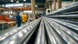 © Nastassia - Close-up of shiny metal pipes stacked in a factory. Smooth surfaces and neat geometry are visible. The atmosphere of industrial production and precision.