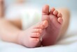 © Tetiana Tati - Newborn baby feet resting on a blanket, symbolizing new life, maternity care, and gentle beginnings. Tiny infant heels. Neonatal health, parenting, and postnatal care. Maternity hospital. Pediatrics