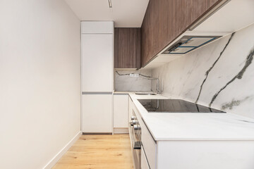 Poster - Modern kitchen design with industrial touches: metal, dark wood, and pendant lights for a cozy, urban feel