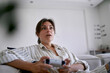 © TrueShot | Westend61 - Surprised woman playing video game at home