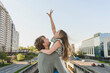 Father carrying cheerful daughter in city
