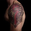 © Ikram - Tribal shoulder tattoo on male arm with red and black ink, intricate geometric patterns, dark studio background, body art and design concept for editorial and creative use