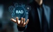 © Ichikawa - Hand holding a holographic RAD concept with gears and icons