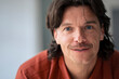 © TrueShot | Westend61 - Mature man with blue eyes and long hair at home