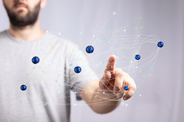 Poster - A person uses a finger to interact with a digital network of interconnected nodes, representing data, connections, or communication.