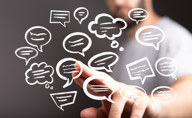 Poster - Stock photo of a man interacting with digital speech bubbles, illustrating communication, social media, or networking.