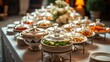 © Graphics - Wedding buffet table adorned with decorative dishes, captured from an overhead view with warm lighting.