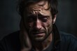 © nsit0108 - Close up portrait of a sad man crying with tears streaming down his face, touching it with his hand