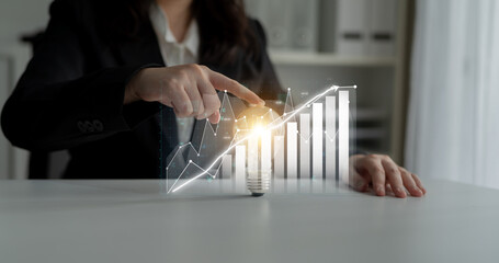 Poster - A business professional highlights data trends with a light bulb symbolizing innovation, showcasing the blend of creativity and analytics for financial growth. Impute