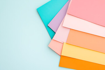 Poster - Colorful paper assortment, a gradient of pastel hues and bright accent tones arranged on a light background. Great for artistic presentations or creative design