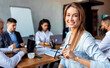 © Prostock-studio - Business Career. Businesswoman Smiling To Camera Sitting On Corporate Meeting With Coworkers In Modern Office. Copy Space