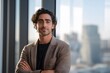 © SITI - Confident Young Entrepreneur with Curly Hair Standing in Modern High-Rise Office with City View