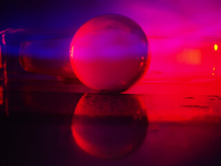Wall Mural - a clear glass ball is sitting on a pedestal. colorful background. abstract graphic background. light