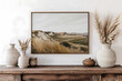 © vasile - An ultrarealistic picture of a landscape wall art hanging above a wooden mantlepiece with neutral decorative items and pampas grass in a textured vase