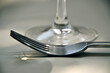 © Aldona - the fork is lying next to the glass and the light is reflected in it