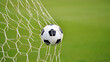 © Murshidi Mahmud Ful - Close-Up Soccer Ball in Goal Net on Green Field Background