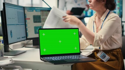 Poster - Corporate staff uses dual monitors to analyze charts with mockup on laptop, preparing strategy reports to improve business management efficiency and achieve objectives for growth. Camera B.