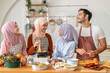 © Art_Photo - Muslim family cooking together in kitchen preparing food with fresh vegetables, islamic holiday gathering with fresh ingredients and family love, halal food preparation for ramadan or eid celebration