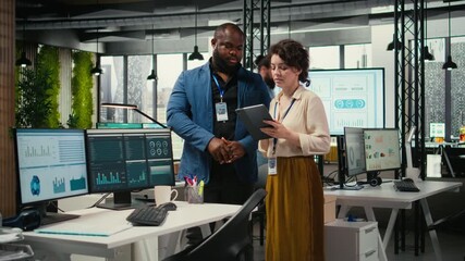 Poster - Diverse workers team use digital tools and analytics to improve growth strategy, reviewing financial insights on tablet to foster innovation and development in a modern office environment. Camera A.