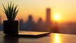 © Rere_Art151 - Silhouetted plant and tablet at sunset, cityscape backdrop.