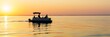 © Ilja - Enjoy a serene sunset fishing scene on the Baltic Sea. A gentle pontoon boat carries fishermen, capturing the beauty of nature and the tranquility of marine recreation.