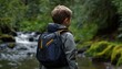 © Mingkwan - Exploring green technology child using solar-powered backpack by clear stream in lush environment