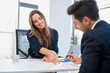 © BusinessClass by W61 - Recruiter assisting candidate filling form at desk in office