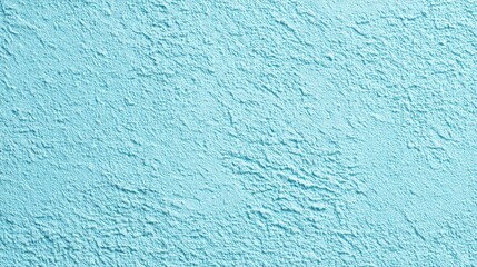 Poster - A calming turquoise wall with a textured surface adds depth and interest to the indoor environment while being bathed in soft natural light.