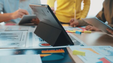 Poster - A dynamic team is engaged in data analysis with a laptop at the center, surrounded by colorful charts and reports, embodying creativity and collaboration in a modern office setting. SACTR
