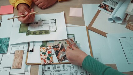 Poster - A creative workspace filled with interior design plans, colorful sticky notes, and hands actively sketching layouts, showcasing the collaborative planning process. SACTR
