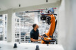© BusinessClass by W61 - Technician examining industrial robot in a factory