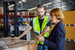 © BusinessClass by W61 - Manager sharing tablet PC with colleague by stocks in warehouse