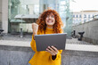 © BusinessClass by W61 - Excited redhead young woman with tablet PC gesturing fist