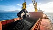 © am - Industrial crane loading coal into a bulk carrier cargo ship, showcasing maritime transport and global energy trade