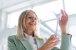 © BusinessClass by W61 - Businesswoman touching blade of wind turbine model at office