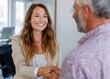 © Ganesha88 - Professional businesswoman shakes hands with male client in modern office setting empowering collaboration