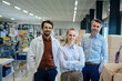 © BusinessClass by W61 - Smiling businesswoman with colleagues in warehouse