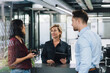 © BusinessClass by W61 - Businesswoman having discussion with colleagues in office