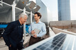 © BusinessClass by W61 - Happy businessmen standing together by solar panel