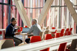 © BusinessClass by W61 - Senior businessman discussing and explaining colleague at table in office