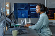 © BusinessClass by W61 - Young computer programmer wearing wireless headphones working on desktop PC