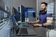 © BusinessClass by W61 - Young computer programmer with wireless headphones working on desktop PC