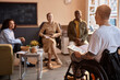© BusinessClass by W61 - Project manager with disability having discussion with colleagues at office