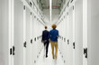 © BusinessClass by W61 - Young engineers walking in server room at data center