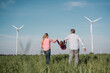 © BusinessClass by W61 - Playful parents swinging daughter in field