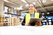 © BusinessClass by W61 - Happy young worker with tablet PC standing in warehouse